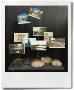 Be creative! Postcards at different heights held by wire on stones.